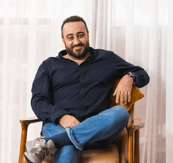 Sam Halcrow seated in an armchair